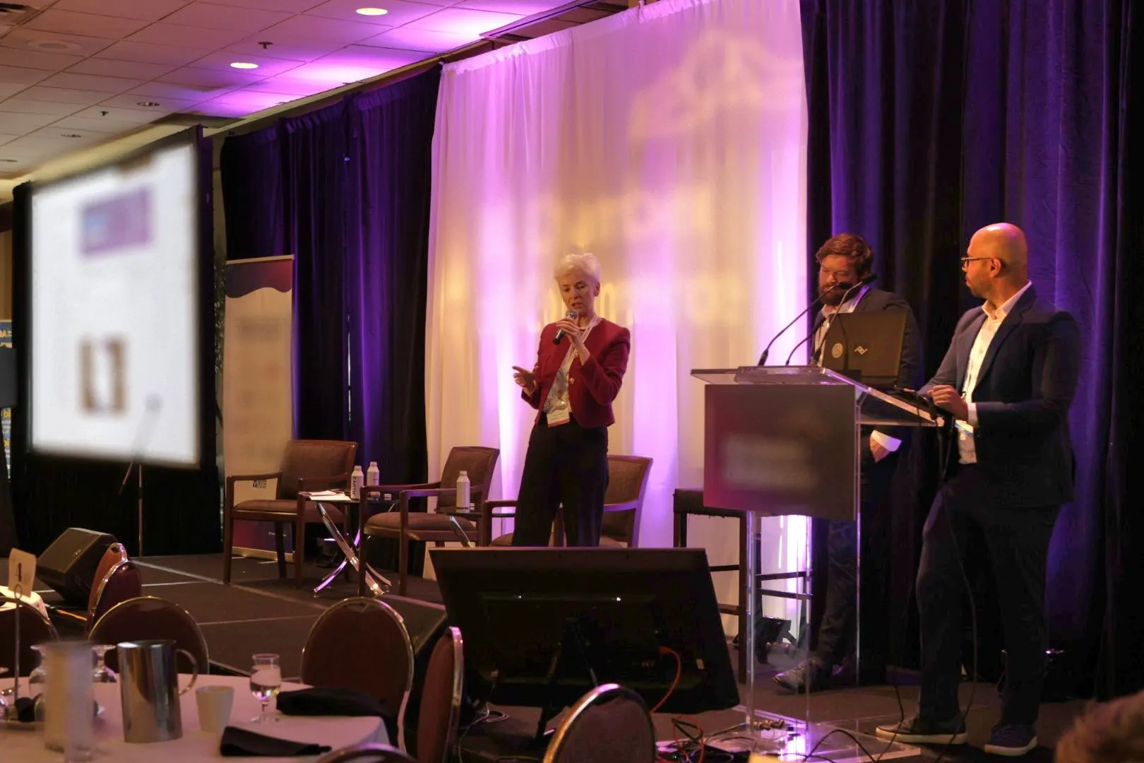 A panel discussion on stage at a chamber of commerce event